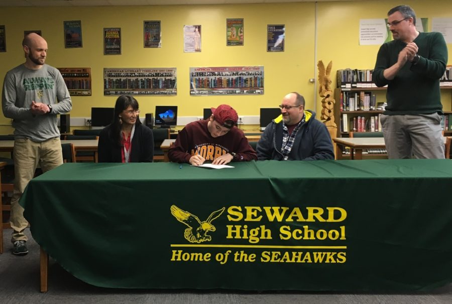 Chris Kingsland seated with parents Valerie and David. Athletic Director Al Plan (left) and Principal Trevan Walker (right).