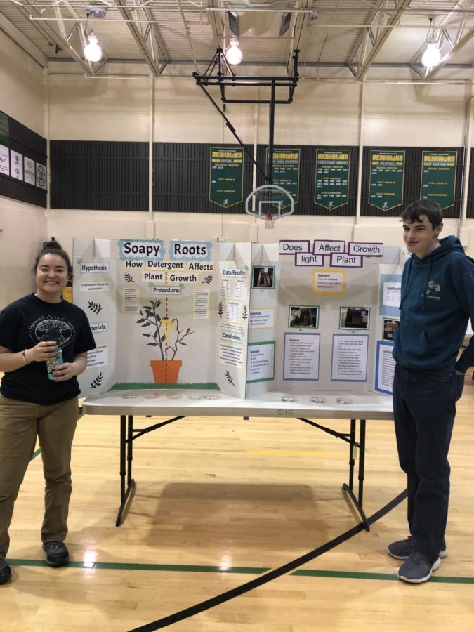 Marisa Phasomsap and Levi DeBoard smiling next to their projects.