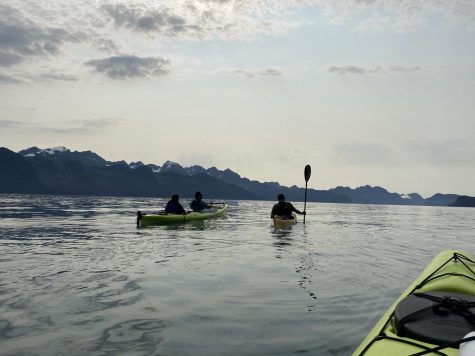 Freshman Sam McLain and Coach Sol share a kayak and chat with our guide Piper.